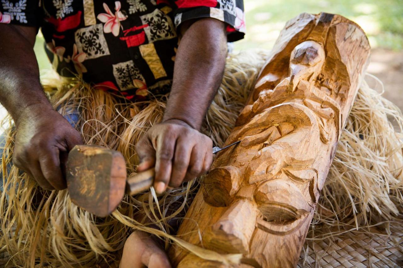 Outrigger Fiji Beach Resort Korotogo Bagian luar foto A man carving a mask in the Solomon Islands