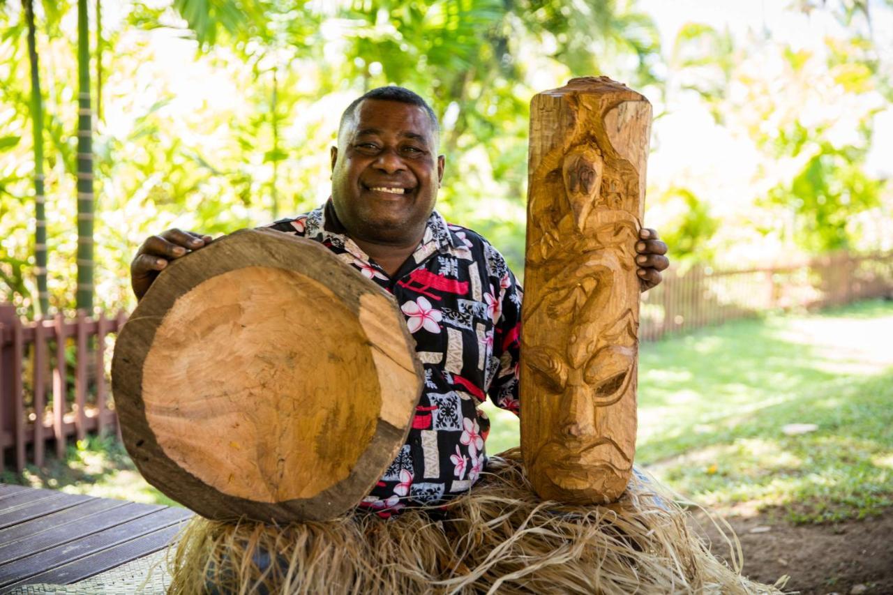 Outrigger Fiji Beach Resort Korotogo Bagian luar foto A man from the Solomon Islands with a drum and a carved post